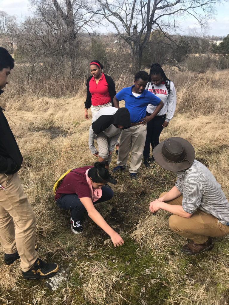 Knowledge Academy students survey the grounds of a future city park.